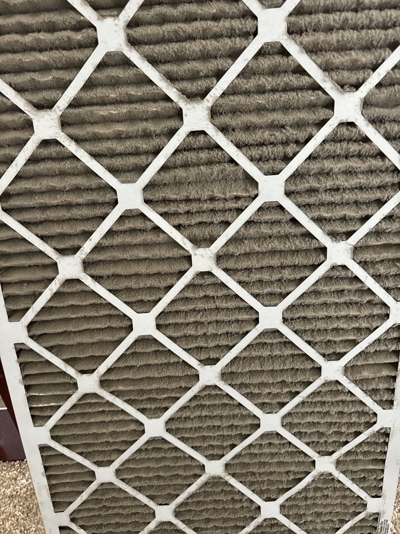 Heco service photo showing dense dust buildup across the pleats of a used air filter
