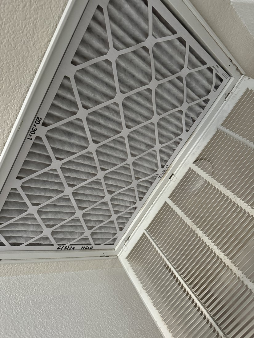 Heco service photo of a replacement 20 by 30 by 1 air filter installed in a ceiling return grille
